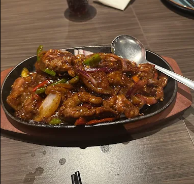 Typical phone photo of a sizzling beef dish